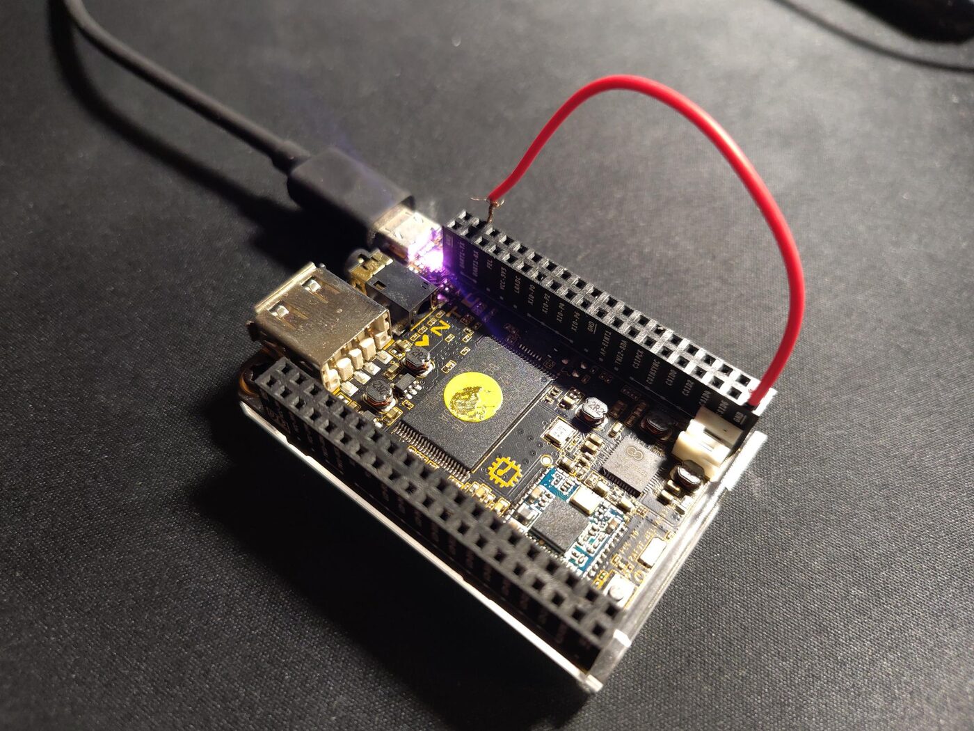 NextThing C.H.I.P. powered over micro-USB, with a red jumper wire connecting the FEL pin to GND